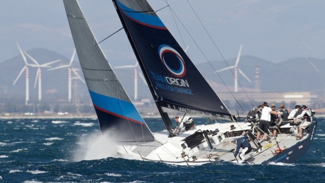 TeamOrigin-TP52-on-the-final-day-of-the-Audi-MedCup-2010.-The-team-which-stood-for-raising-awareness-of-climate-change-heads-fittingly-into-a-backdrop-of-wind-turbines-off-the-Italian-coast-Ian-Rom-665x374.jpg