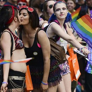 couple shares a kiss during the capital pride parade on bank e1439740494692